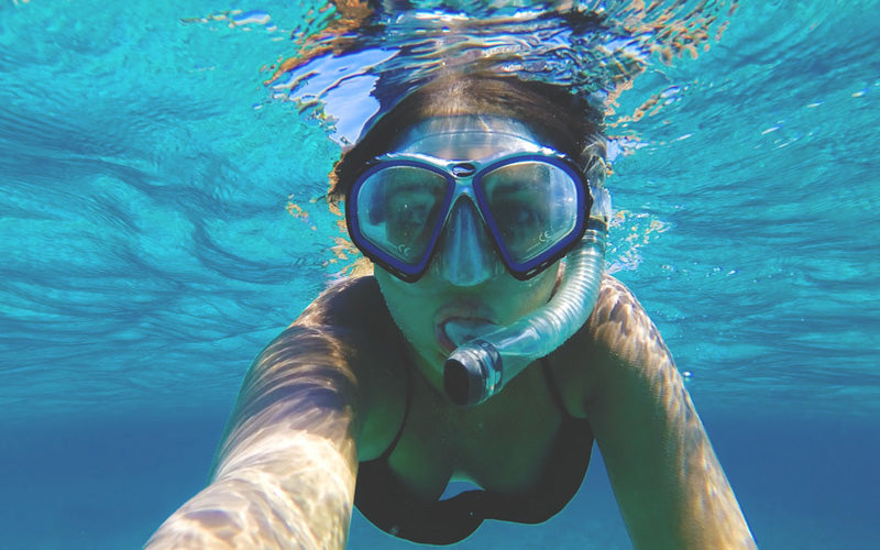 woman wearing water goggles underwater in Turks and Caicos