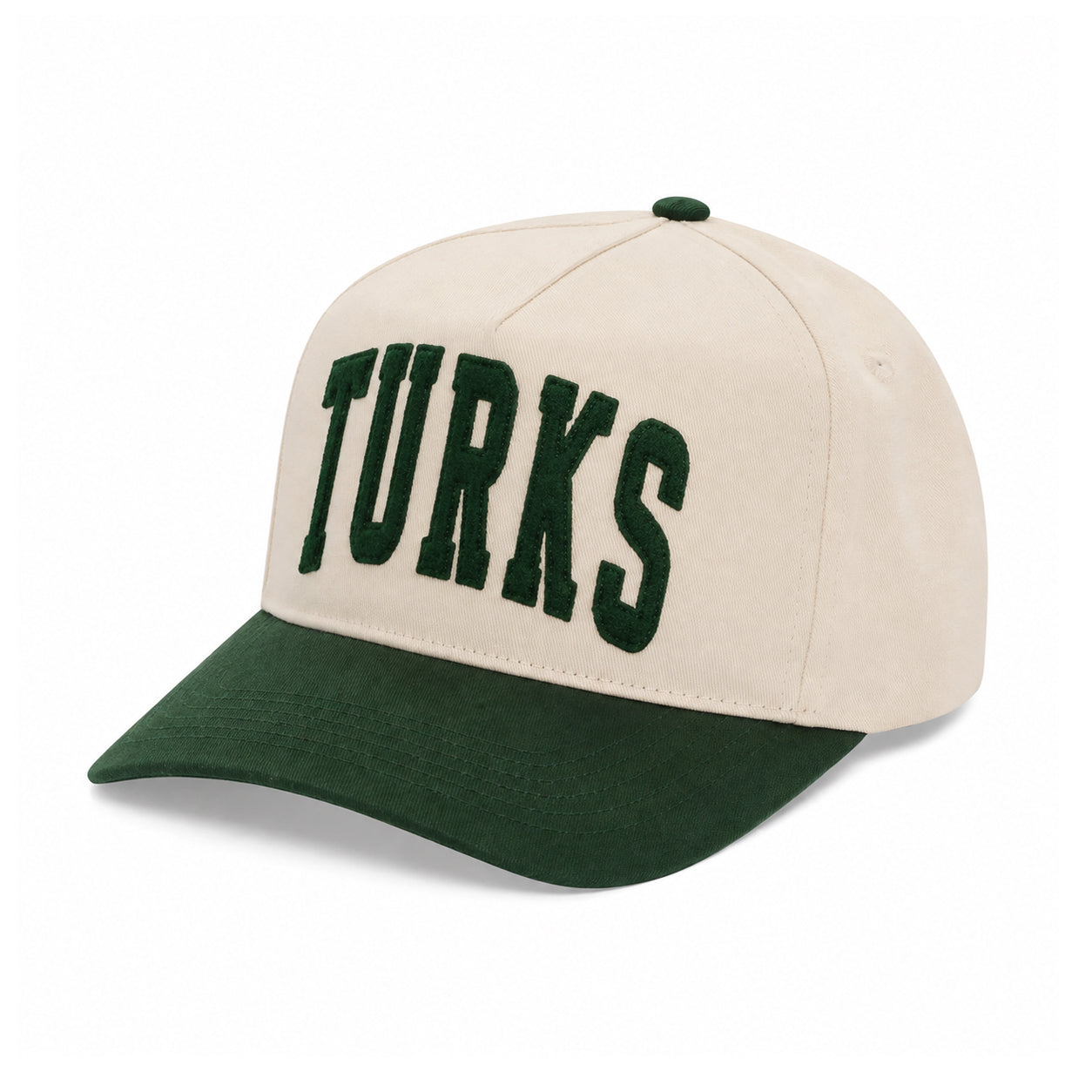 A structured baseball cap with a cream-colored crown and a dark green curved brim, featuring the word 'TURKS' embroidered in dark green varsity-style block letters across the front panels.