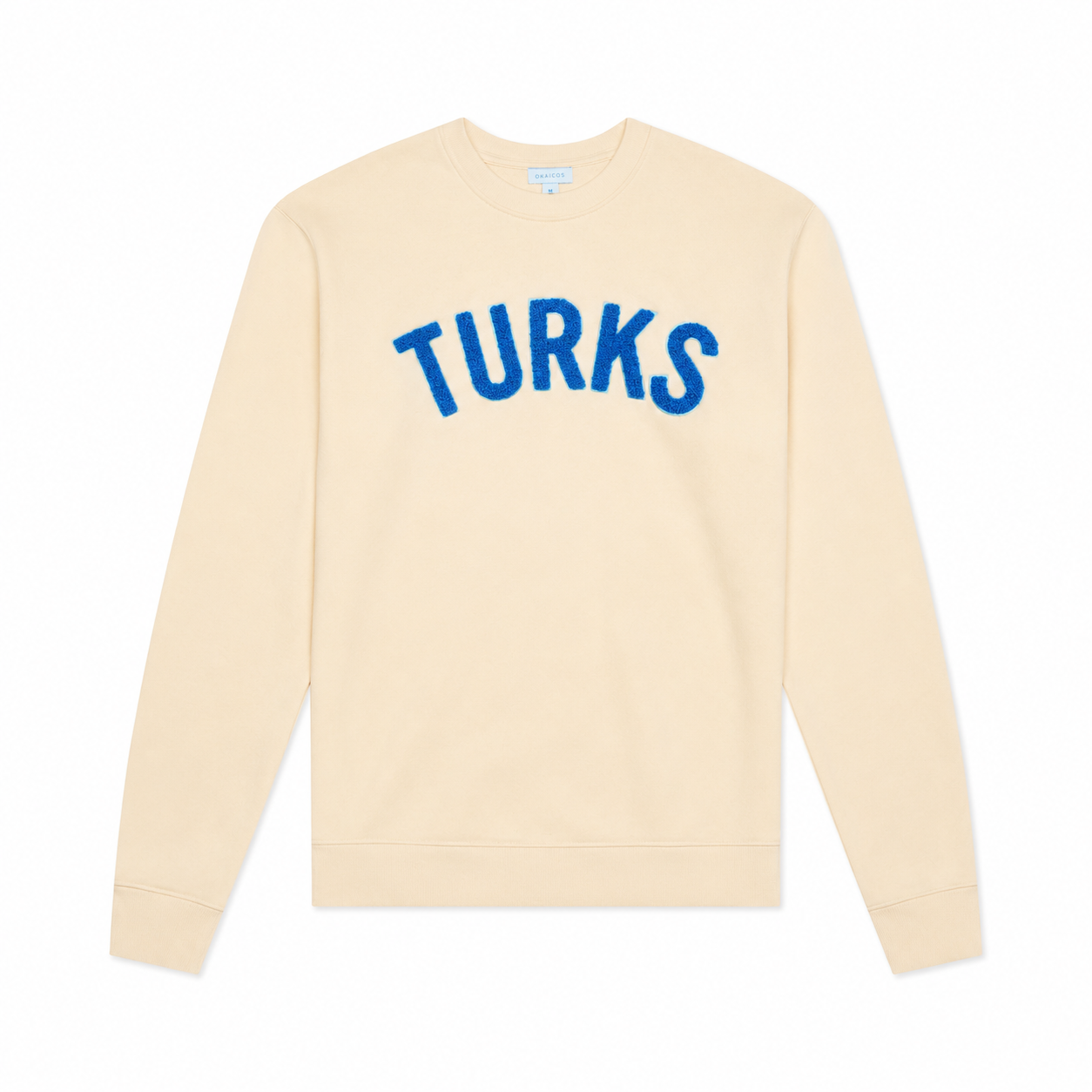 A cream-colored crewneck sweatshirt with the word 'TURKS' printed across the chest in blue arched letters, displayed on a clean white background.
