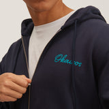 OKAICOS-Navy Embroidered Zip Up Hoodie Sweatshirt Embroidered Turks And Caicos On Model Close Up