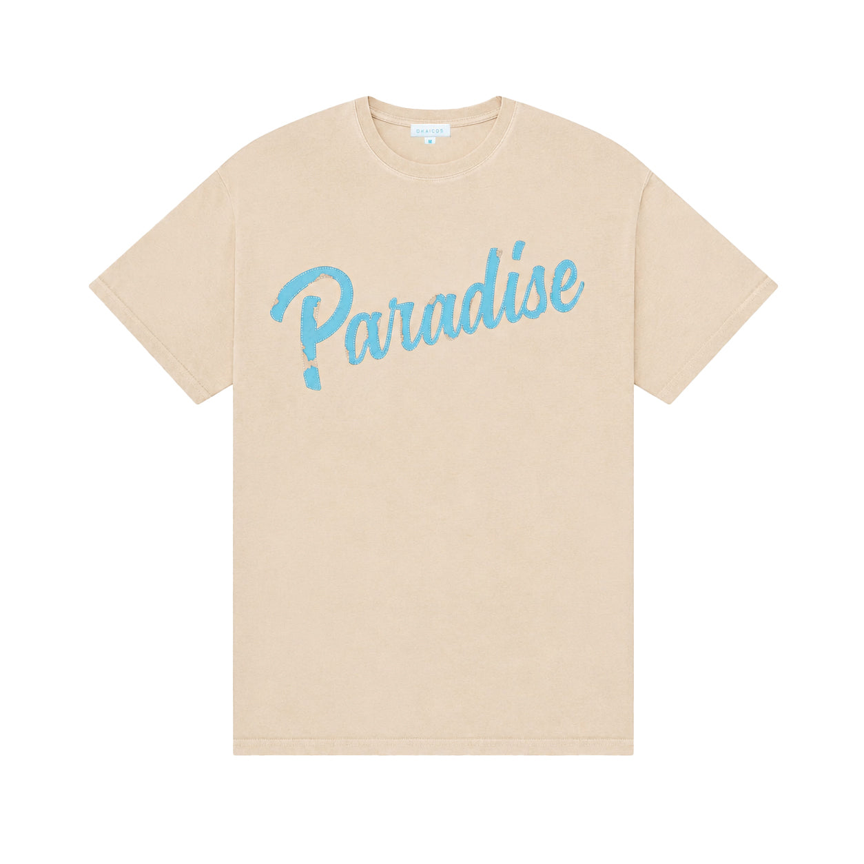 A beige short-sleeve crewneck t-shirt featuring the word 'Paradise' printed across the chest in a light blue cursive script, displayed against a solid white background.