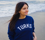 OKAICOS Navy Chenille Embroidered Crewneck Cotton Sweatshirt Embroidered Turks And Caicos On Model Beach
