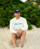 OKAICOS Chenille Embroidered Crewneck White Turks and Caicos Sitting In Sand