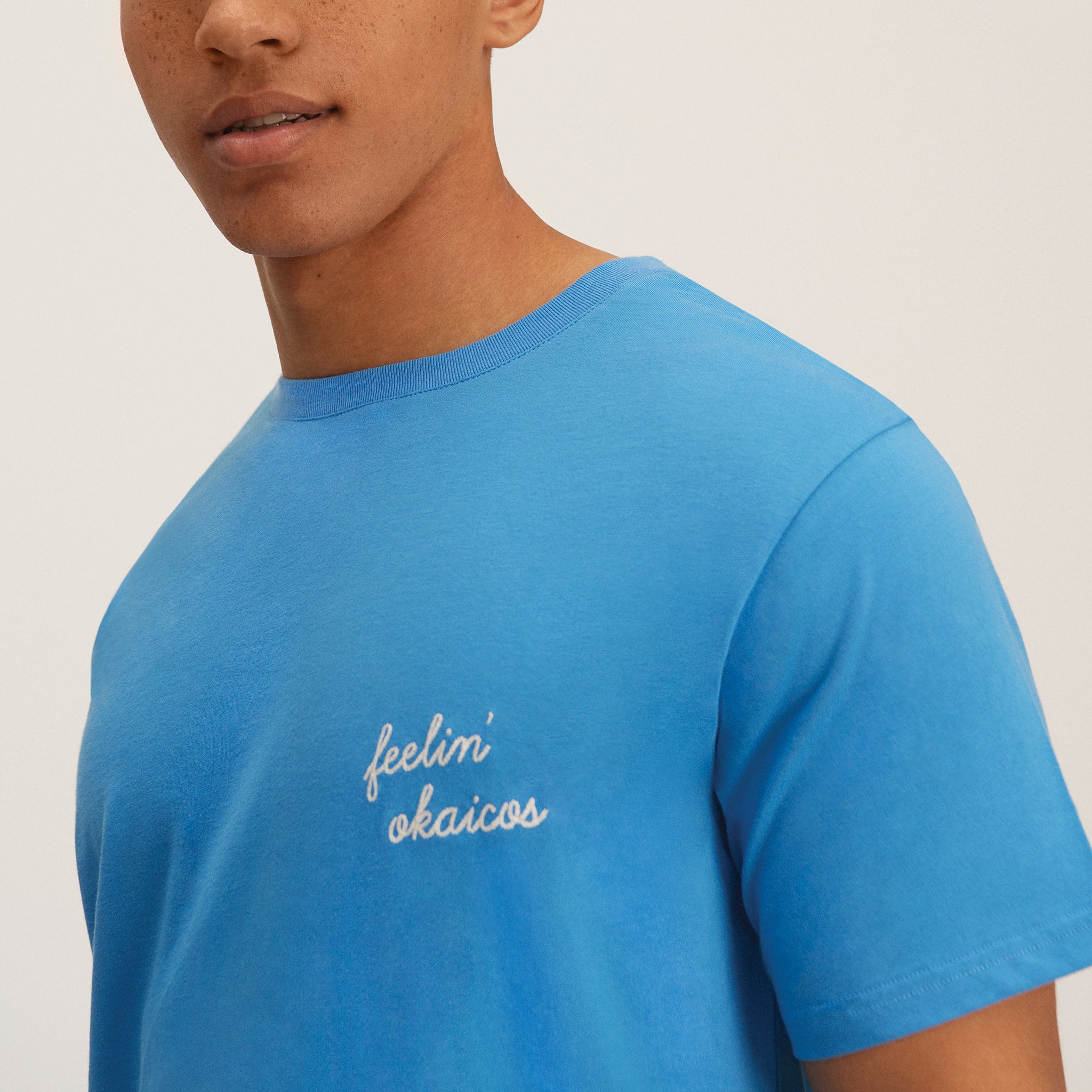 OKAICOS Blue Lightweight Breathable TShirt Feelin OKAICOS Cursive Chain Stitch Close Up